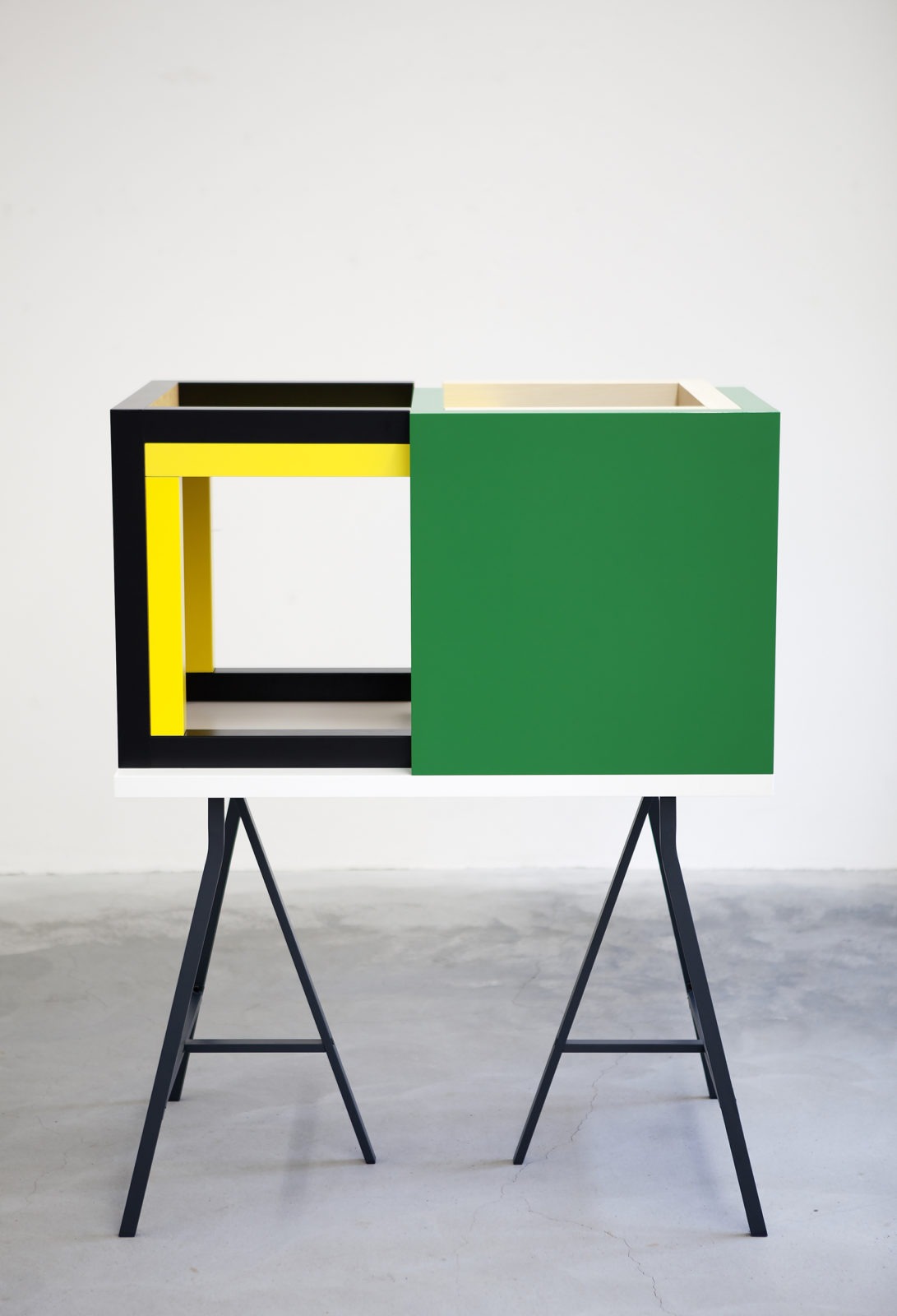 Four LACK tables, a tabletop and two LERBERG trestles combined into a rectangular showcase on legs with partly open sides.