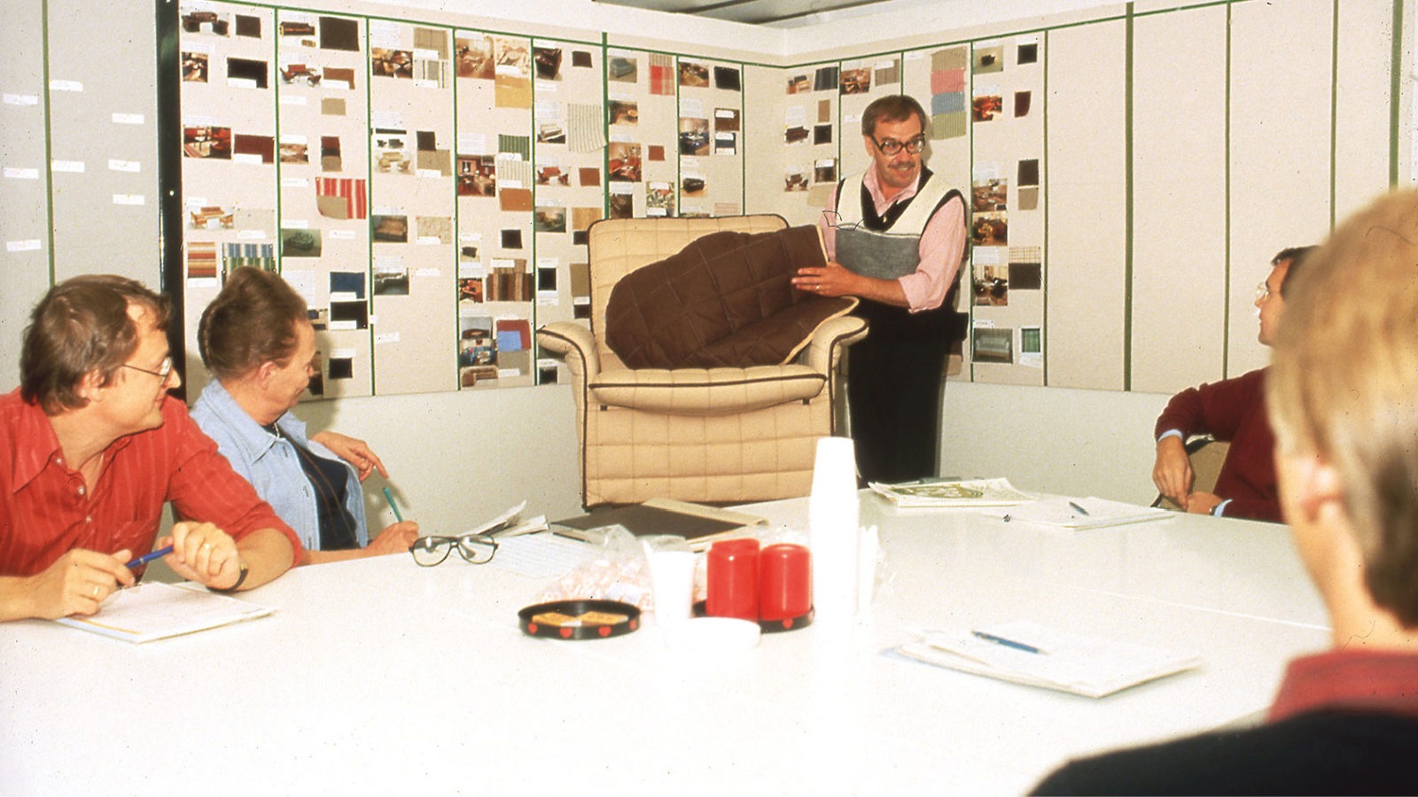 Gillis Lundgren, shows the TULLANÄS armchair to co-workers at IKEA.