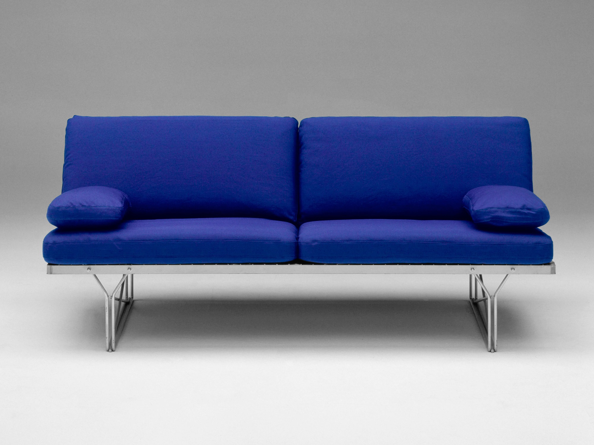Sofa made from metal wire frame, and blue upholstery.
