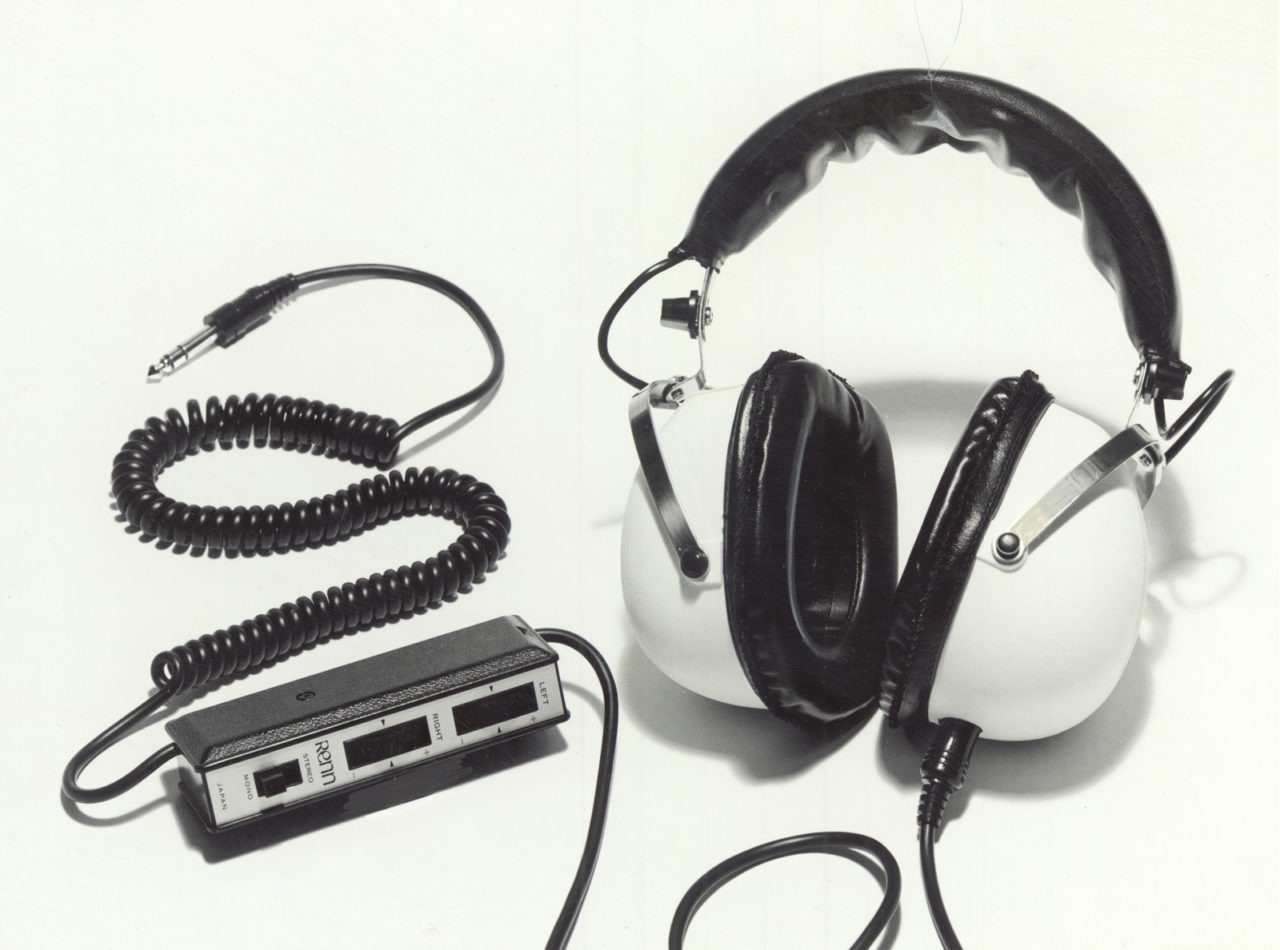 White and black IKEA RENN headphones from 1973 with metal details and a black cord.