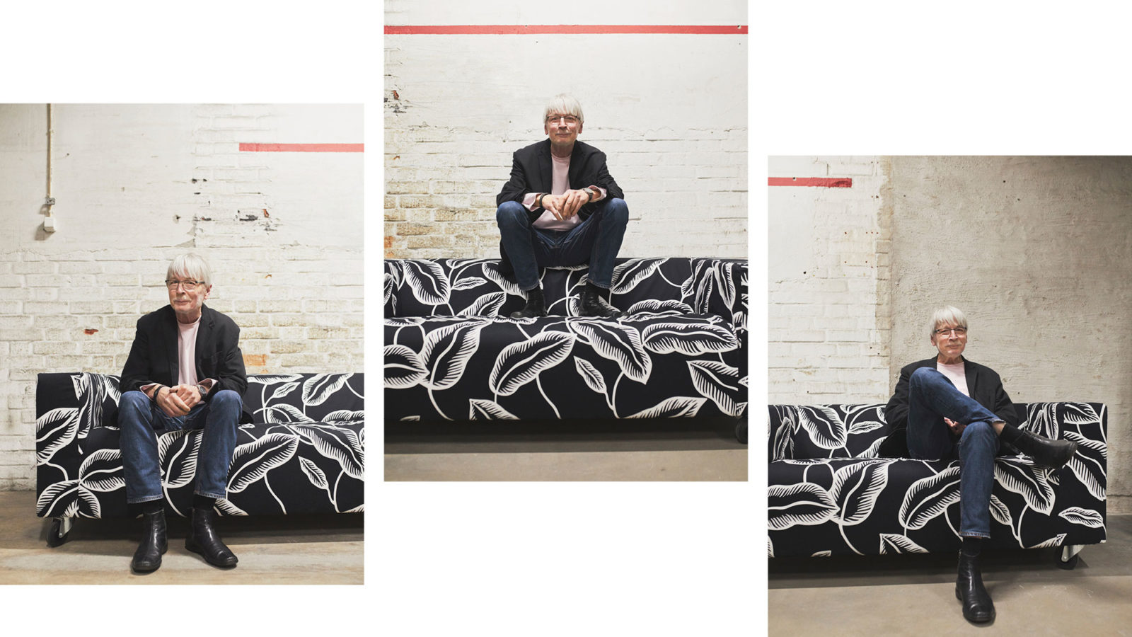 Greying man with glasses, blue jeans, black jacket and long-sleeved t-shirt sits in black and white patterned KLIPPAN sofa.