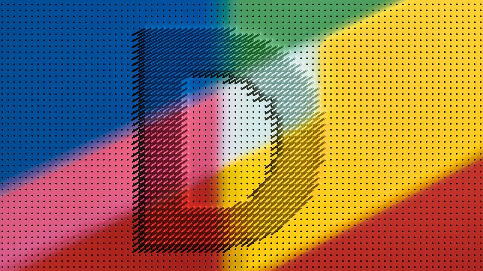A perforated board in blue, pink, yellow and red colours, plugs placed in holes in the middle, forming the letter D.