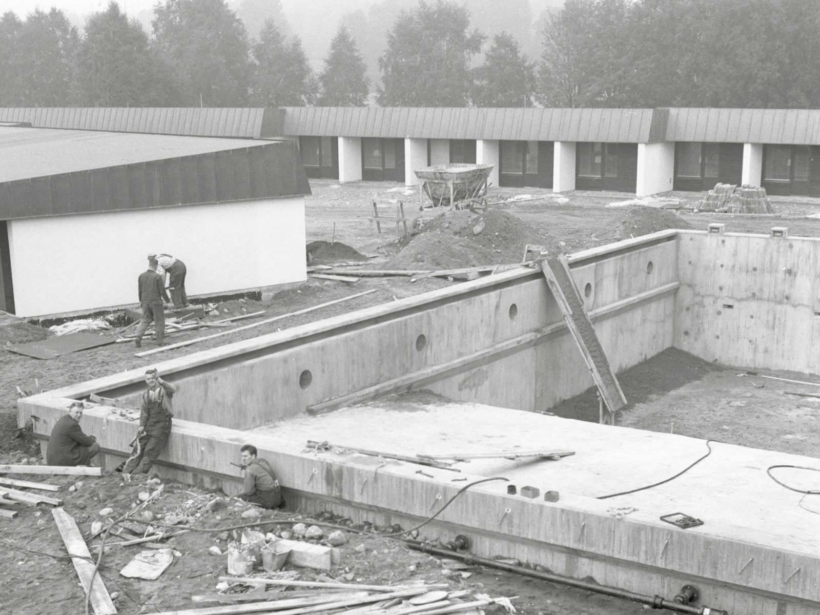 Construction site, excavation for pool and low semi-finished buildings with motel rooms.