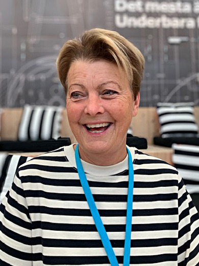 Smiling blonde woman, Catti Bengtsson, wearing a black and white striped shirt.