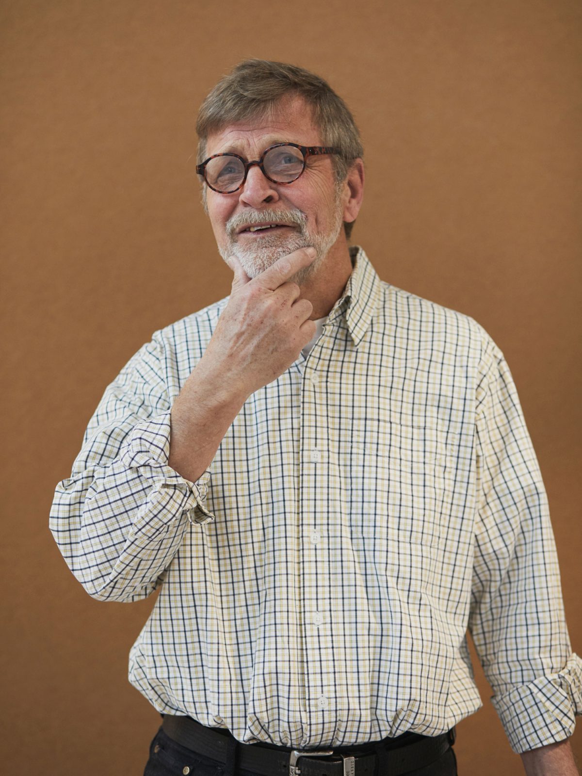 A grey-haired middle-aged man, Jan Ahlsén, wearing glasses and a check shirt.