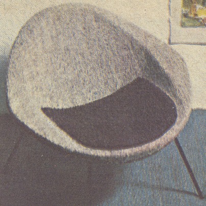Lightweight grey and black rounded 1960s armchair.
