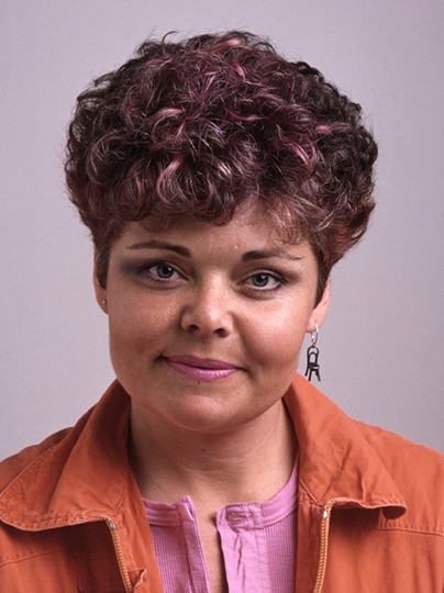 Anna Efverlund as a young woman with short brown hair in a 1980s hairstyle.