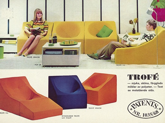 Couple seated in 1960s living room with polyurethane low chairs in bright yellow.