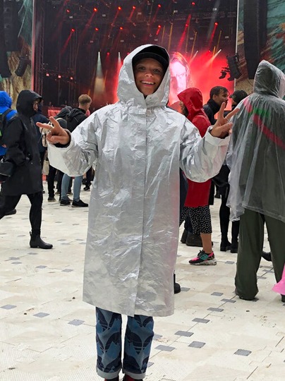 Girl in shiny silver raincoat.