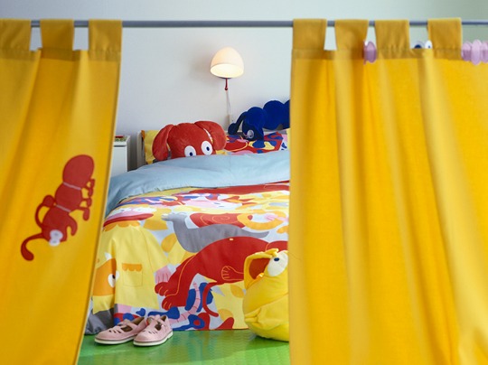 Children's bedroom decorated with colourful textiles.