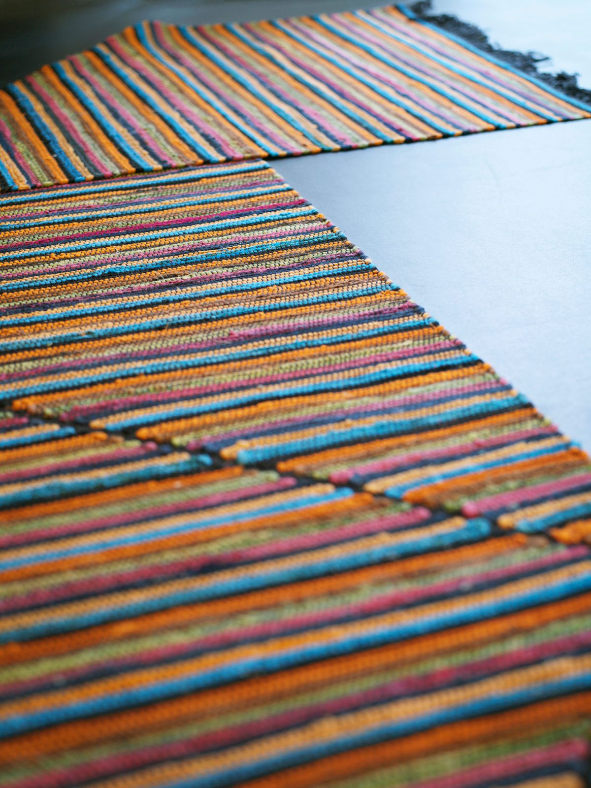 Striped rag rug woven with hinges.