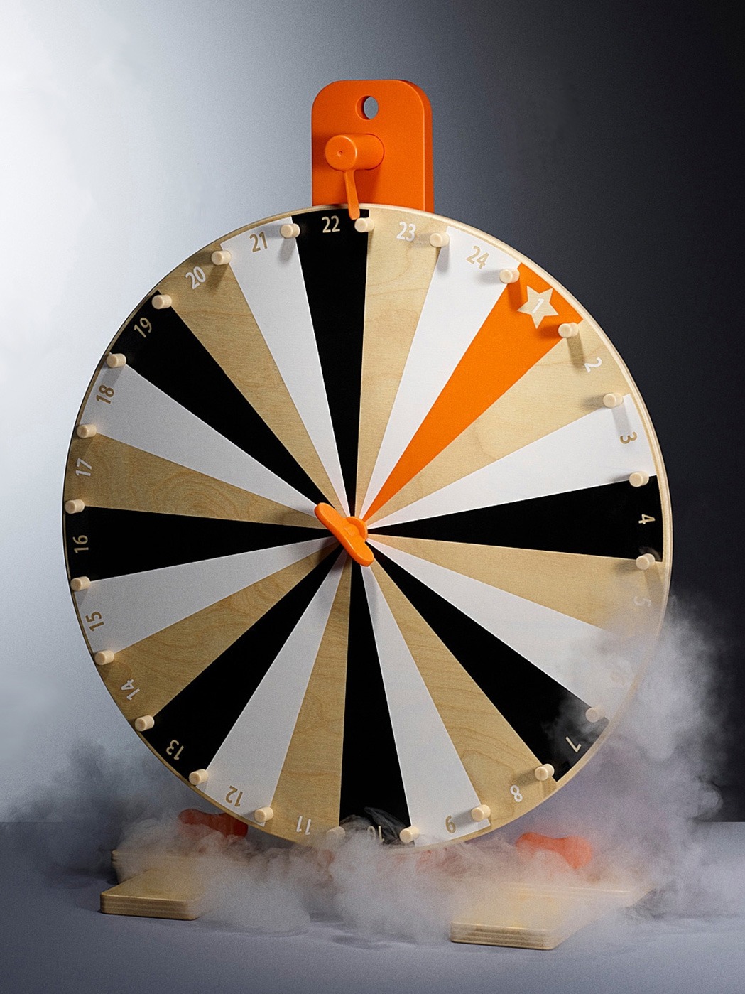 Wheel of fortune made of wood in muted colours and orange.