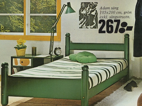 Broad single bed made of green tainted wood with striped bedcover.