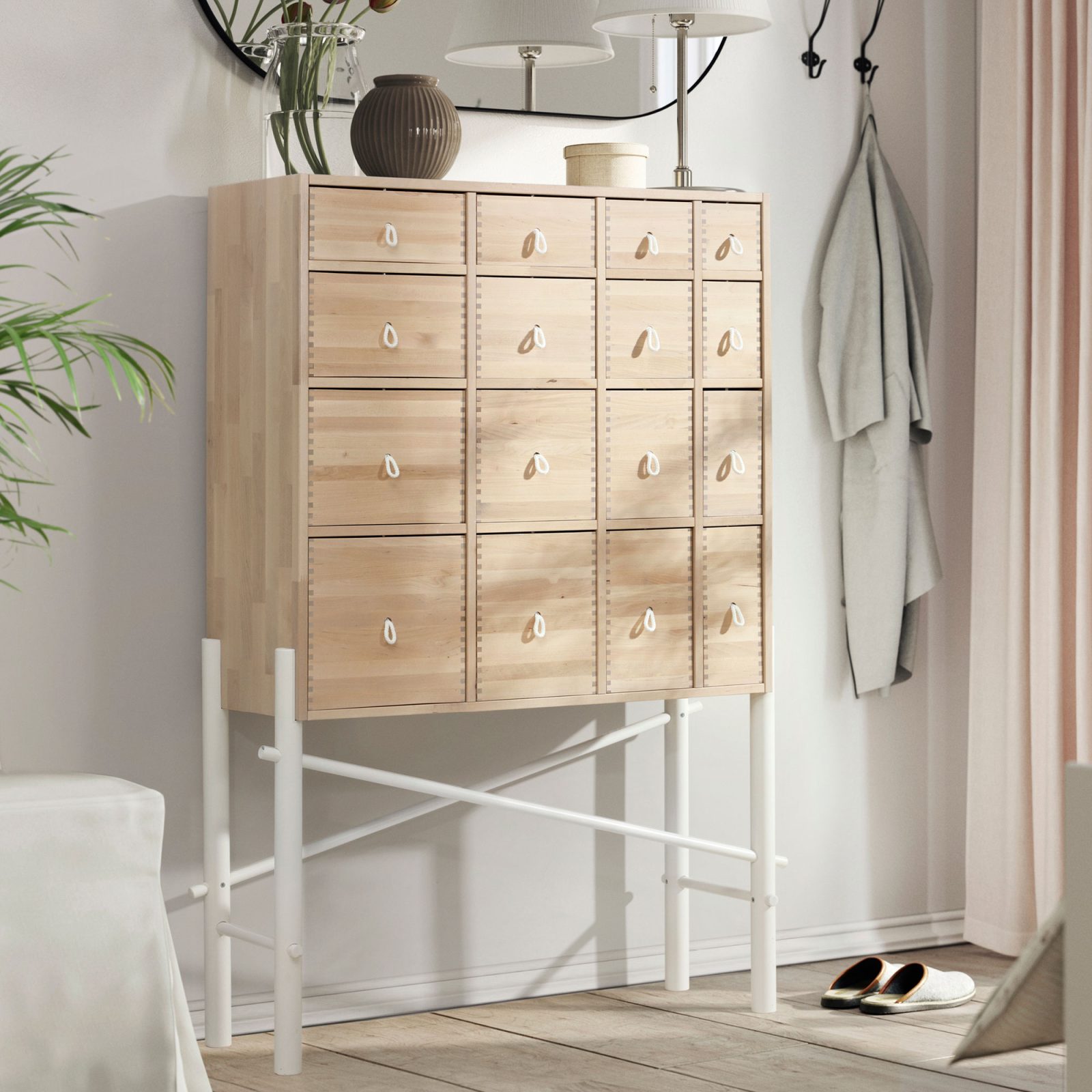 Blond wood cabinet with many drawers in different sizes.