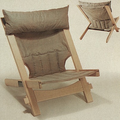 Beach style chair with blond wood and dark beige cushions.