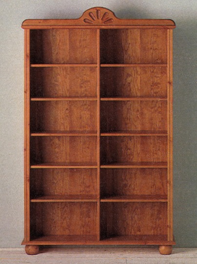 GAMMELSTAD bookcase made of patinated pine with a carved decoration on top.