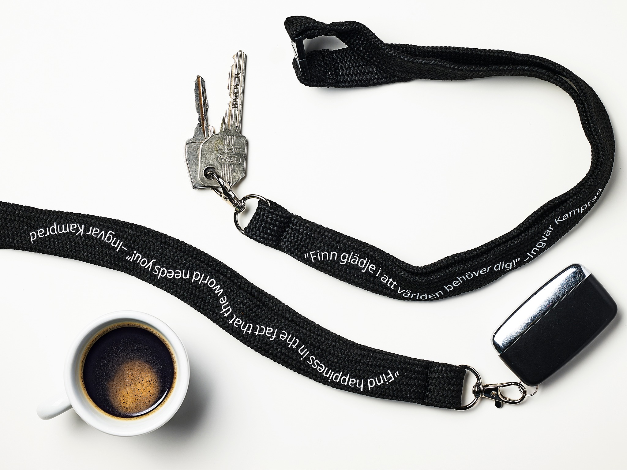 Two keys with black lanyards.