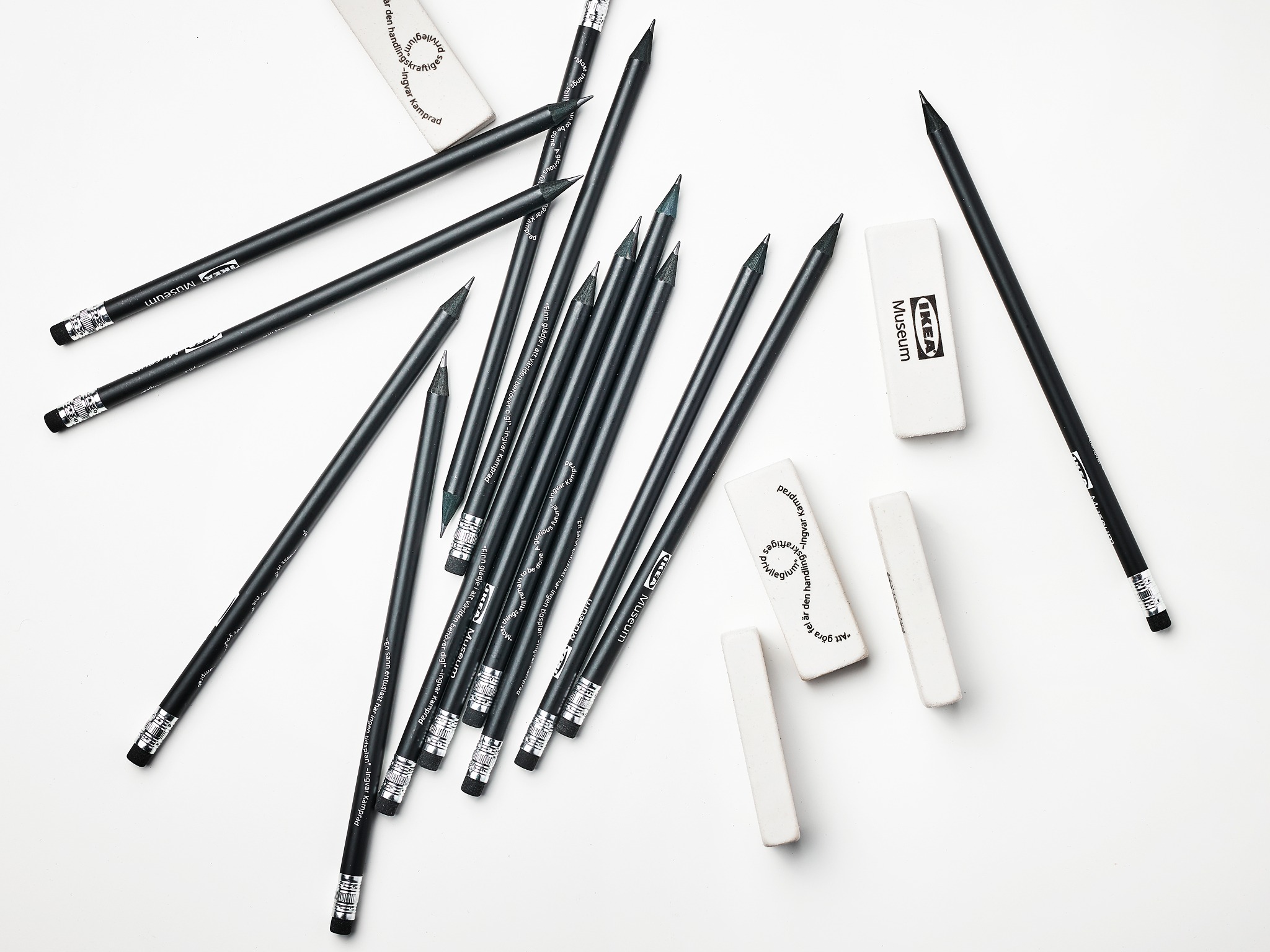 Black pencils and erasers scattered casually around.